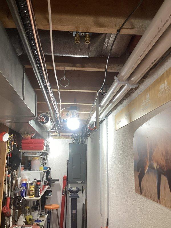 Successfully completed installation of complete HVAC system including a 70,000 BTU furnace, 3-ton AC unit, and humidifier in residential basement utility area. System required mechanical and electrical permits, with all ductwork properly connected and PVC venting installed according to code requirements.