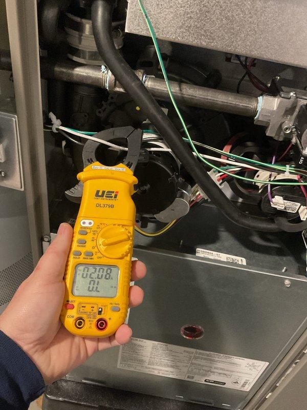 Performed scheduled furnace tune-up on 10-year-old unit with no reported issues. Conducted comprehensive electrical testing using UEi DL379B clamp meter, checking DC current readings (measured at 2.08 and 0.54) on internal components. Inspected all electrical connections, wiring, and mechanical systems; documented condition with photos for service record. Unit operating within specifications; next maintenance due 2025.