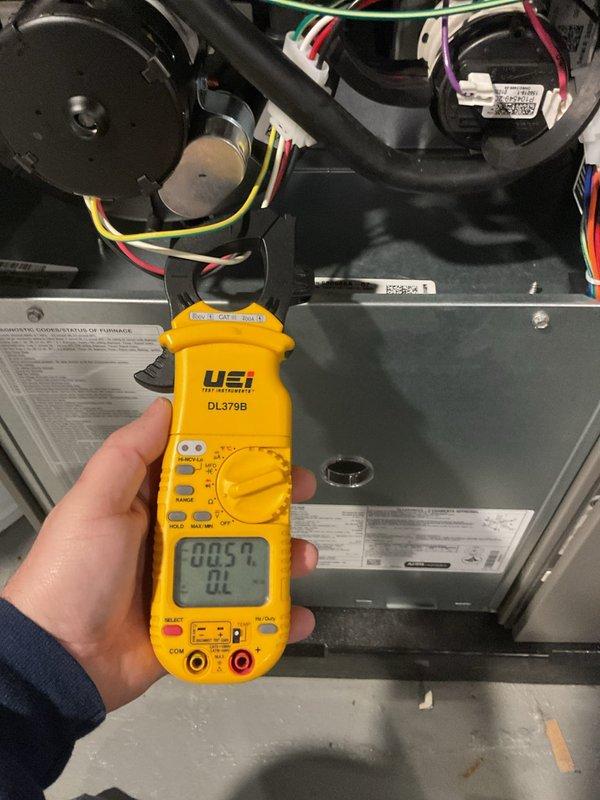 Performed scheduled furnace tune-up on 10-year-old unit with no reported issues. Conducted comprehensive electrical testing using UEi DL379B clamp meter, checking DC current readings (measured at 2.08 and 0.54) on internal components. Inspected all electrical connections, wiring, and mechanical systems; documented condition with photos for service record. Unit operating within specifications; next maintenance due 2025.