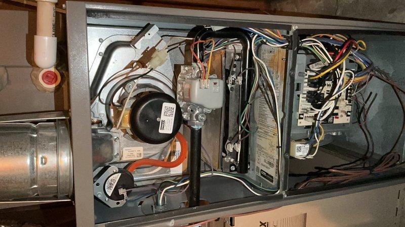 Performed routine air handler maintenance service including filter inspection and replacement. Inspected blower motor and fan operation, which were functioning properly. Examined electrical components, control board connections, and gas valve assembly - all found in normal working condition with no signs of malfunction. Completed system check and documented with photos showing interior components.