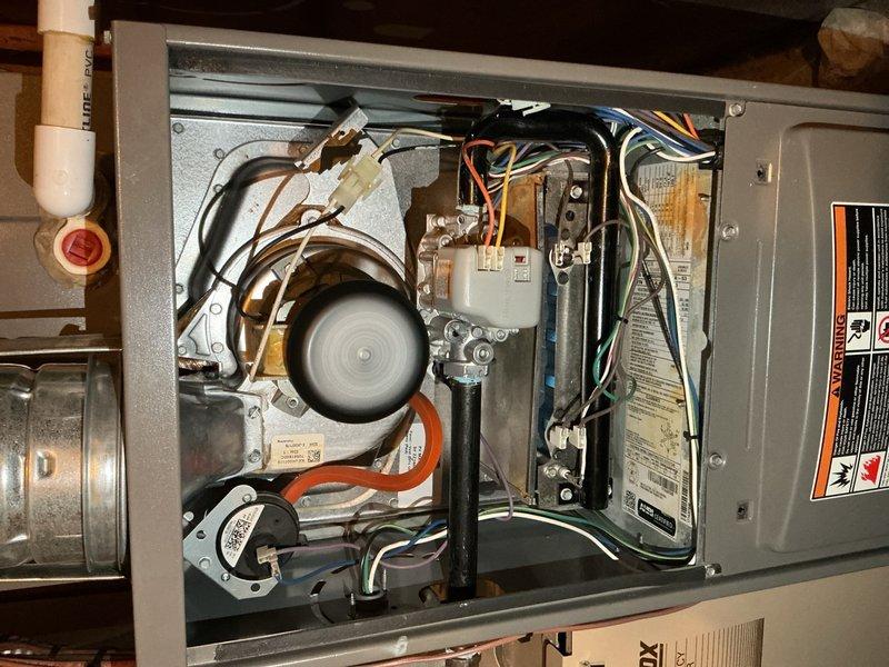 Performed routine air handler maintenance service including filter inspection and replacement. Inspected blower motor and fan operation, which were functioning properly. Examined electrical components, control board connections, and gas valve assembly - all found in normal working condition with no signs of malfunction. Completed system check and documented with photos showing interior components.