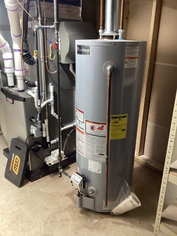 Performed diagnostic assessment on Lochinvar tanked water heater (installed January 2020) in mechanical room. Inspected all connections, including copper and PVC piping, and evaluated unit's operational status. No active leaks observed despite minor historical staining around base; system currently functioning within normal parameters.