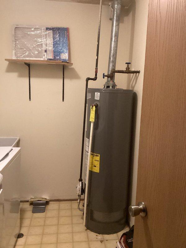 Diagnosed and repaired leaking tank-style water heater in laundry room of 7-year-old residence. Inspected copper supply lines, valve connections, and T&P relief valve, identifying source of leak and implementing necessary repairs to restore proper operation. System was pressure-tested after repair to confirm leak resolution and ensure safe, compliant functionality.