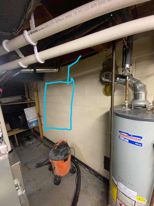 Conducted assessment for new tankless water heater installation in basement utility room. Current American standard tank-type water heater is non-operational and will be replaced with a new tankless unit. Evaluated existing plumbing infrastructure, including PVC piping and venting requirements, and marked installation location on wall for upcoming work.