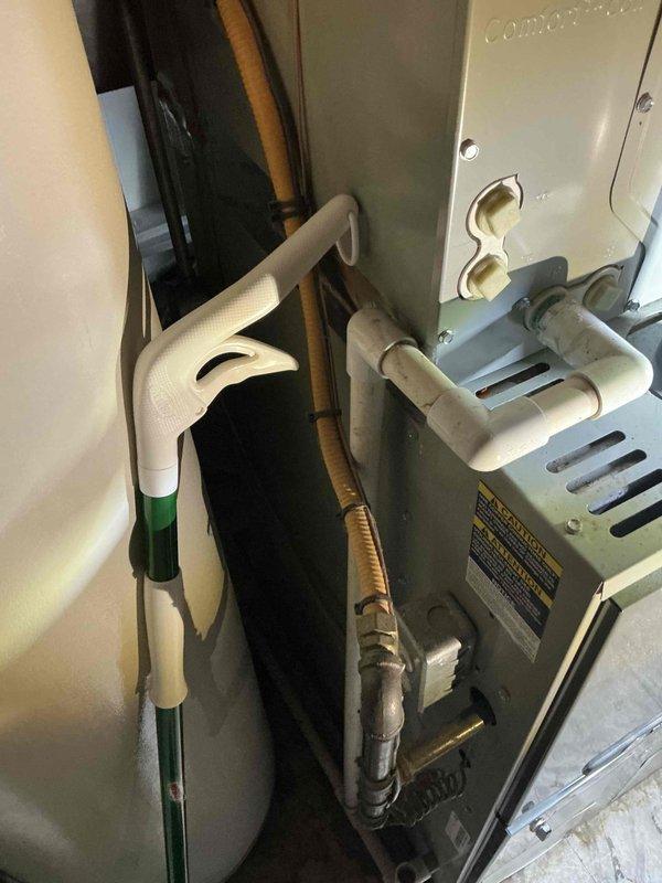 Completed inspection of 16-year-old Trane XR14 AC system for replacement estimate. Evaluated existing installation including furnace/air handler, refrigerant line set, condensate pump, and associated PVC drainage components. Documented current configuration in unfinished basement area with photos to develop appropriate replacement solution for customer who requires system replacement within the next few weeks.