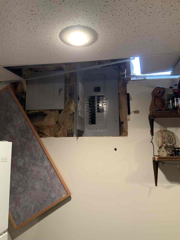 Conducted full system evaluation of 33-year-old forced air natural gas system in ranch home with basement installation. Inspected electrical panel for proper amperage capacity and documented existing water heater specifications (Smith 100) with current venting configuration. System replacement estimate provided for furnace and A/C components.