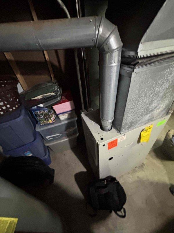 Conducted assessment of 20+ year old natural gas furnace located in basement. Furnace is currently operational but showing significant age. Evaluated existing galvanized ductwork system, including main trunk lines and connections, and documented current installation configuration for replacement estimate. Provided comprehensive quote for complete furnace system replacement.