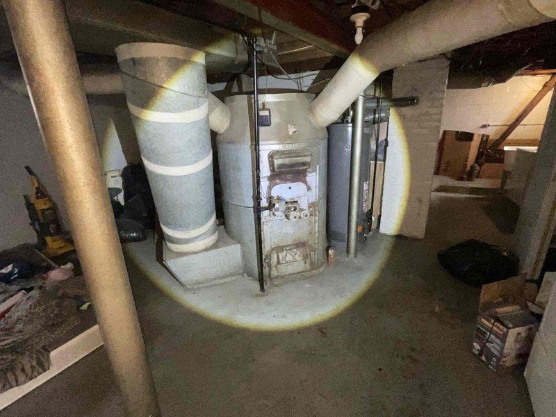 Completed inspection of 40+ year old non-functional octopus gravity furnace system that was red-tagged by DTE due to safety concerns. Provided estimate for conversion to modern forced air system, noting current installation in basement with natural gas fuel source. Thermostat location and current ductwork configuration were documented to facilitate proper system design for the gravity-to-forced-air conversion.