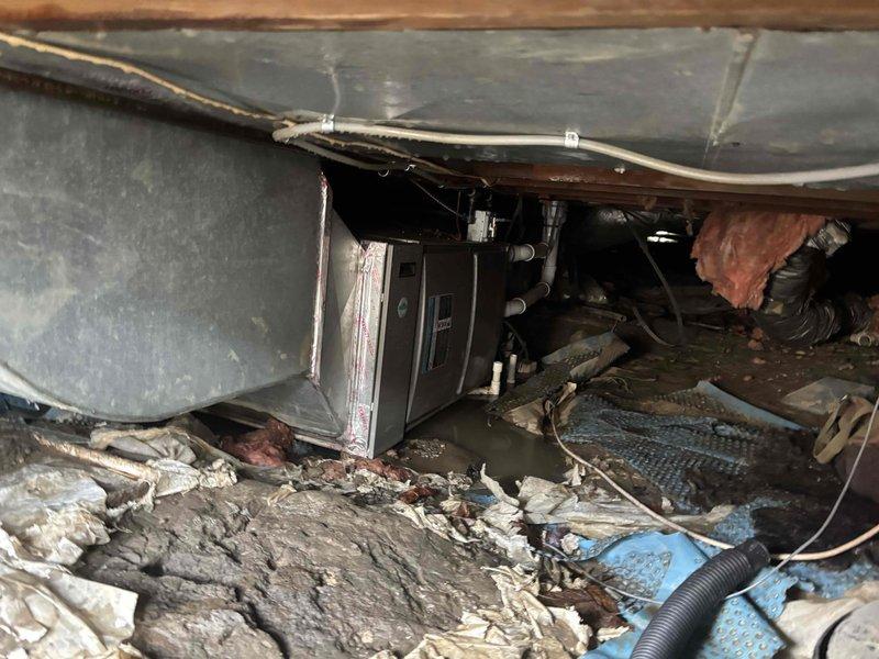 Performed assessment of flood-damaged HVAC system in crawl space, where unit had been submerged in approximately 6 inches of water, voiding manufacturer warranty. Recommended full system replacement with new Lennox ML296UH110XV60C furnace and CK40HT-48C coil due to water damage to the existing one-year-old unit.