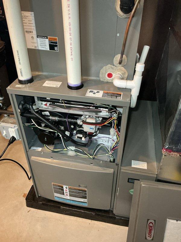 Performed scheduled heating maintenance on a high-efficiency furnace per membership agreement. Conducted full system inspection with front panel removed, examining control board, wiring, and mechanical components. System is operating correctly with no issues identified; verified proper venting through PVC intake/exhaust pipes and confirmed drainage system functionality.