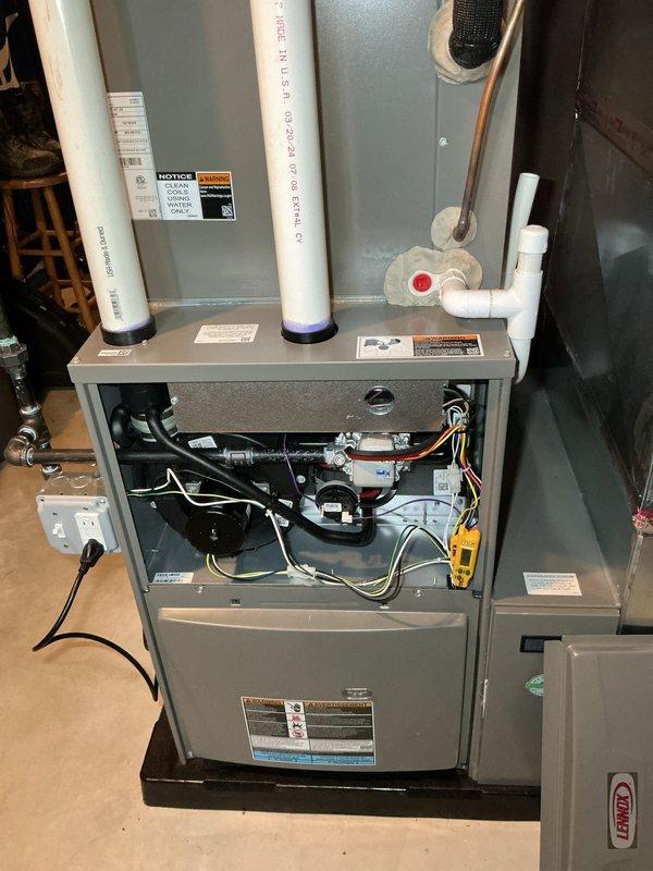 Performed scheduled heating maintenance on a high-efficiency furnace per membership agreement. Conducted full system inspection with front panel removed, examining control board, wiring, and mechanical components. System is operating correctly with no issues identified; verified proper venting through PVC intake/exhaust pipes and confirmed drainage system functionality.