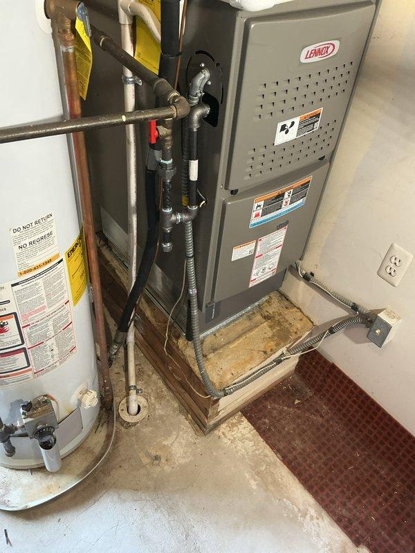Successfully completed installation of a complete HVAC system, including a 70,000 BTU furnace and 1.5-ton AC unit with rear placement. System features a new Lennox furnace mounted on platform with proper ductwork connections, including installation of required mechanical and electrical components with all permits secured.
