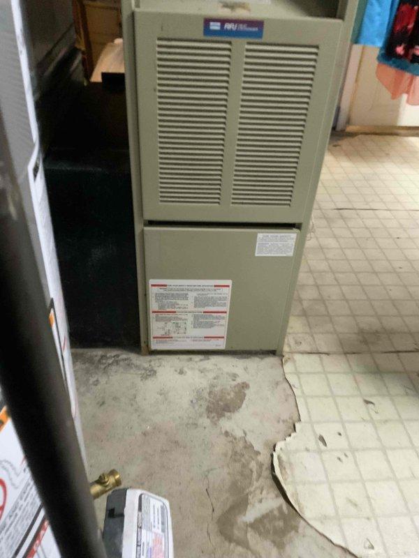 Conducted comprehensive assessment of 16-year-old Comfortmaker HVAC system for replacement quote. System is installed in utility area with visible floor damage surrounding unit. Customer requires new air conditioning installation within one month.