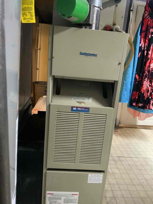 Conducted comprehensive assessment of 16-year-old Comfortmaker HVAC system for replacement quote. System is installed in utility area with visible floor damage surrounding unit. Customer requires new air conditioning installation within one month.