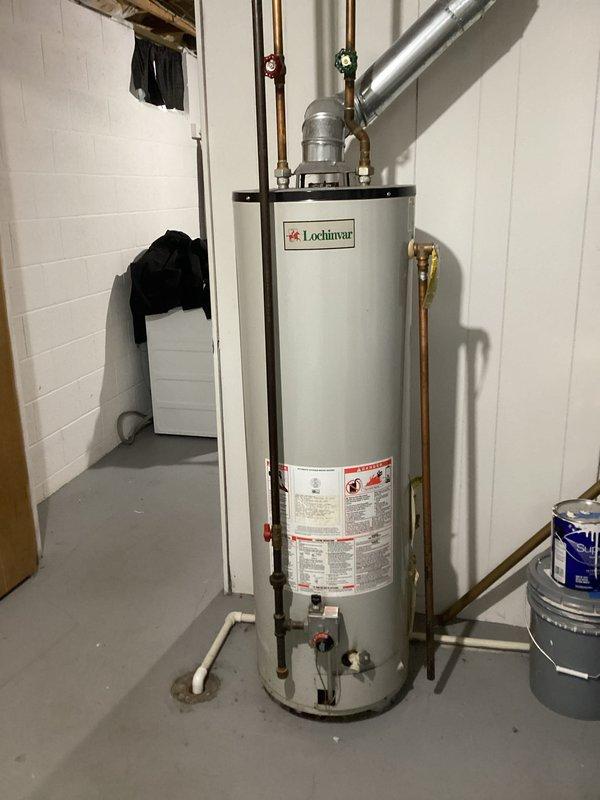 Responded to no hot water complaint on Lochinvar water heater. Diagnosed faulty thermocouple and pilot assembly. Replaced thermocouple, cleaned pilot assembly, and verified proper ignition. Unit now functioning correctly with consistent hot water supply.