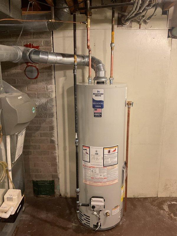 Successfully installed a 40-gallon Bradford White tanked water heater in basement utility room. Completed all necessary plumbing connections including copper supply lines and proper metal venting ductwork. Mechanical and hot water heater permits were requested and reconnection was completed according to code requirements.