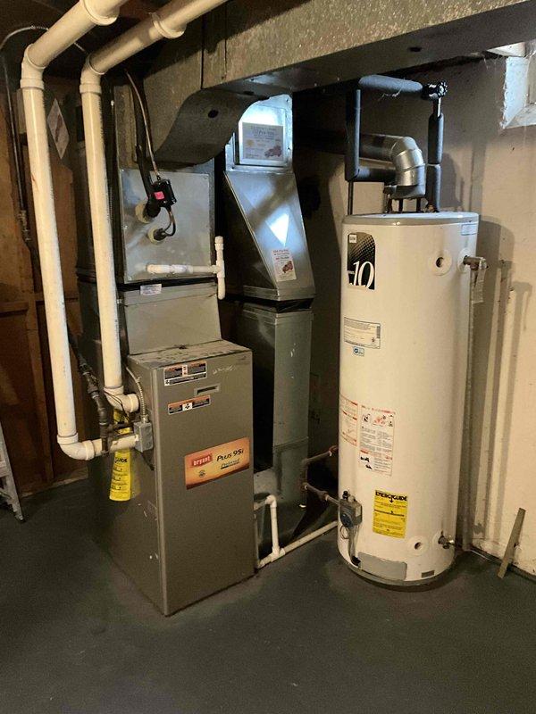 Completed service estimate for replacement of 16-year-old Bryant Plus 90 gas furnace and water heater located in basement. Current equipment is operational but aging. Documented existing installation including ductwork configuration, PVC ventilation system, and connection points to prepare comprehensive replacement proposal for high-efficiency alternatives.