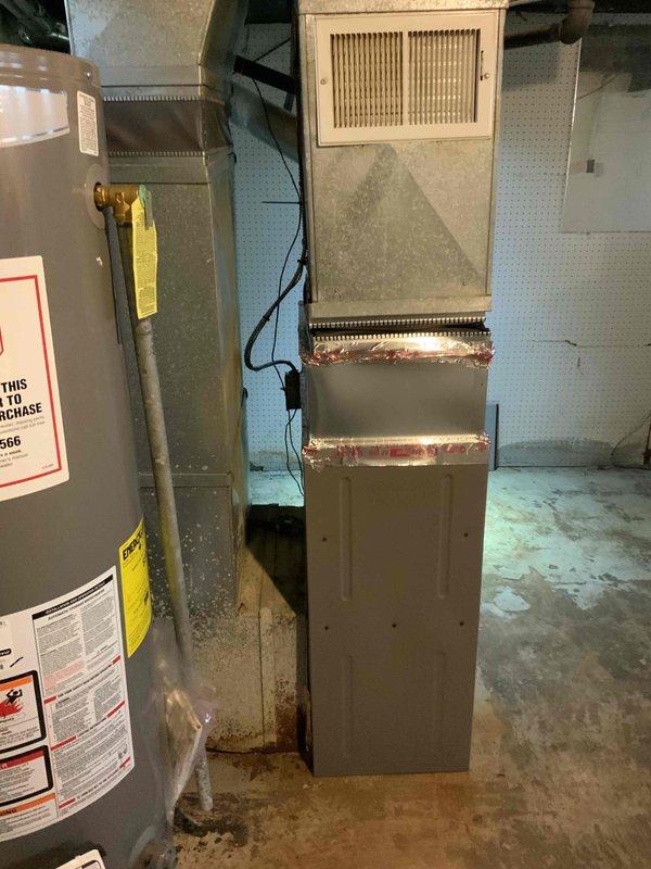 Inspected customer's existing HVAC system and identified a non-code compliant furnace installation that presents liability concerns. Documented the current installation with photos showing improper ductwork connections and ventilation issues. Provided full system replacement estimate with recommendation for immediate action due to safety concerns.
