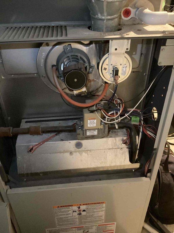 Performed comprehensive annual furnace maintenance on 10-year-old unit with Clean Maintenance Warranty valid through 2025. Inspected and cleaned interior components including blower motor assembly, circuit board connections, and ventilation system, noting normal dust accumulation consistent with operational age. All electrical components and PVC drainage connections verified to be functioning properly with no issues detected.