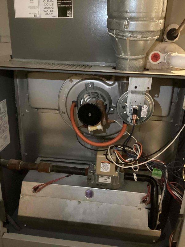 Performed comprehensive annual furnace maintenance on 10-year-old unit with Clean Maintenance Warranty valid through 2025. Inspected and cleaned interior components including blower motor assembly, circuit board connections, and ventilation system, noting normal dust accumulation consistent with operational age. All electrical components and PVC drainage connections verified to be functioning properly with no issues detected.