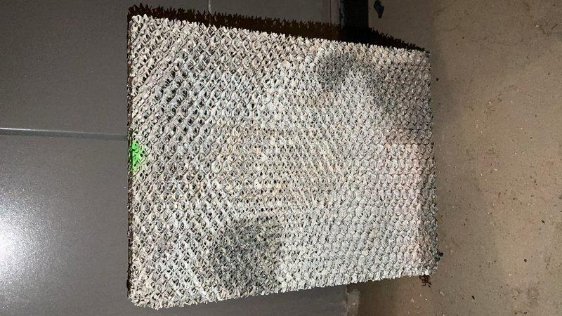 Responded to service call for 2015 furnace leaking water located in basement. Inspected system and found clogged air filter and deteriorated evaporator/humidifier pad requiring replacement. Installed new components to resolve water leakage issue and restore proper system operation.