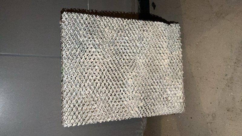 Responded to service call for 2015 furnace leaking water located in basement. Inspected system and found clogged air filter and deteriorated evaporator/humidifier pad requiring replacement. Installed new components to resolve water leakage issue and restore proper system operation.