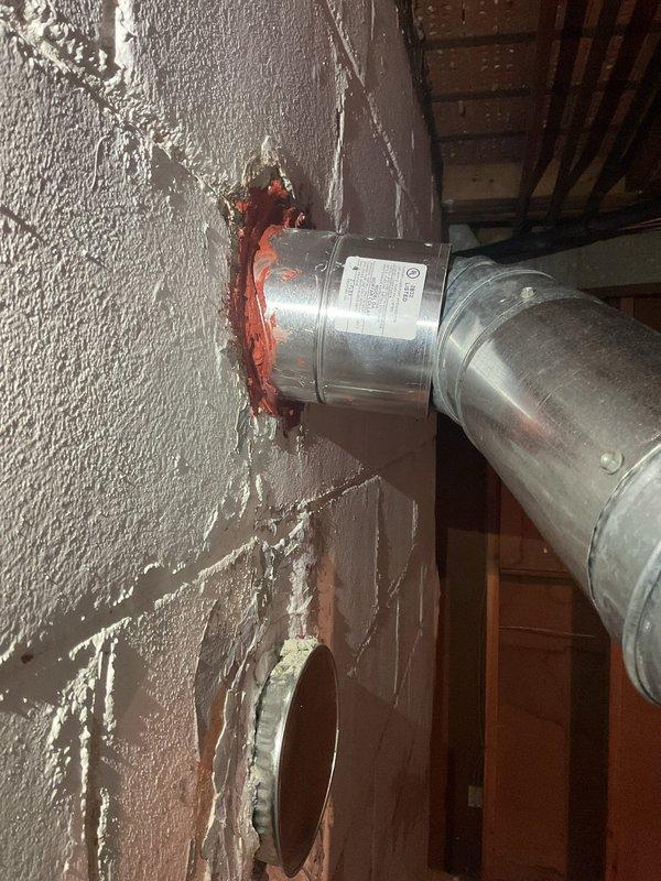 Returned to complete installation by dropping chimney liner and installed magnet strip for air filter as required. Verified proper connection of metal ductwork to wall penetration and confirmed water heater vent pipe system was correctly installed with appropriate clearances.