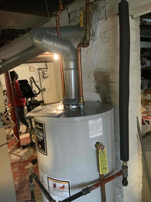 Conducted comprehensive assessment for new AC installation in residential property with no existing cooling system. Inspected current heating infrastructure, which includes a functional furnace with connected ductwork in the basement utility area. Documented water heater location and existing ventilation to evaluate complete HVAC integration requirements for proposed cooling system.