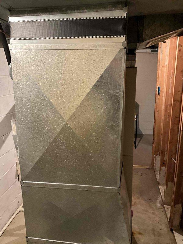 Performed inspection of 20-year-old HVAC system located in basement. Unit is currently operational but approaching end of service life. Provided replacement estimate for furnace and A/C components based on assessment of existing equipment and installation environment, which includes limited utility space with concrete floor and block walls.