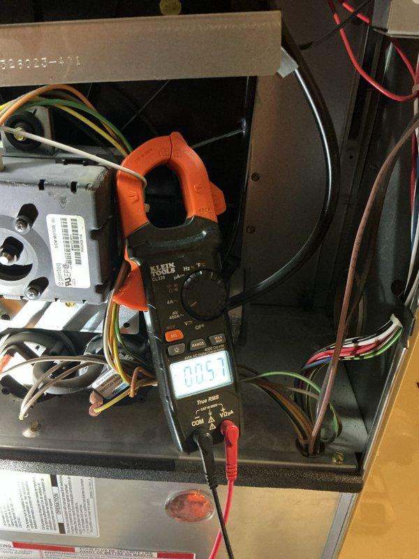 Responded to service call for 15-year-old furnace leaking water located in basement. Performed diagnostic testing using clamp meter which showed 0.57 amp reading on electrical components. Verified thermostat was functioning correctly with heat set to 70 degrees. No parts replaced as issue was identified and resolved during service visit.