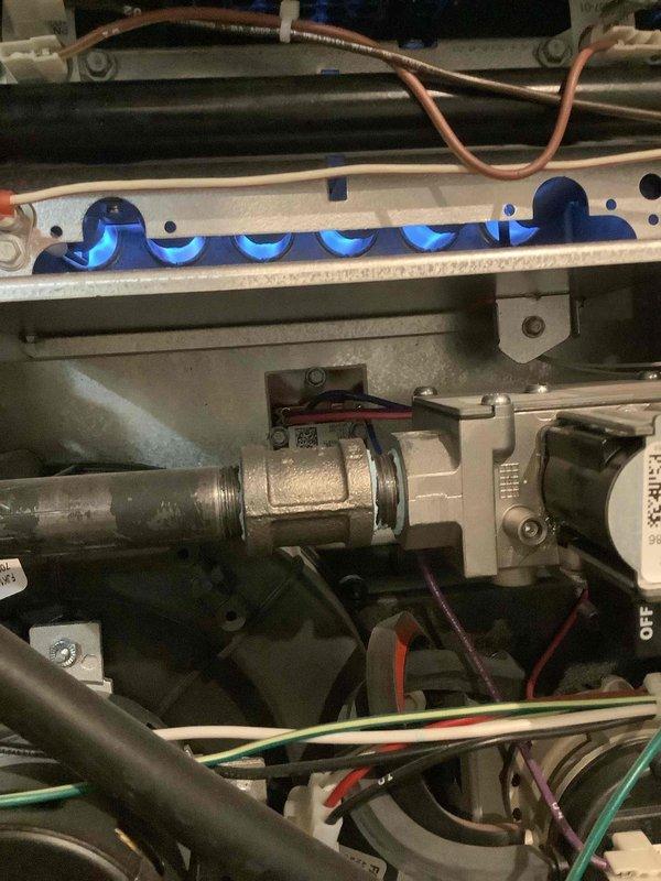Performed annual maintenance on furnace system. Inspected burner assembly confirming proper blue flame pattern and clean combustion. Examined evaporator coil which showed some dust accumulation along the lower portion; recommended regular filter changes to prevent further buildup.