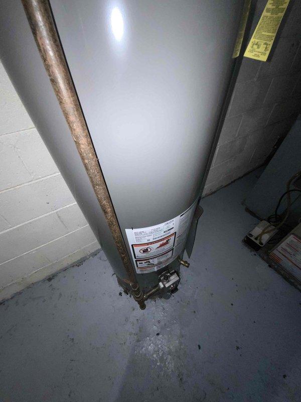 Conducted an estimate for replacement of a non-operational 35+ year old furnace located in the basement. Documented existing HVAC setup including the furnace unit with connected ductwork and nearby water heater installation. Evaluation confirms replacement is necessary due to equipment age and failure.