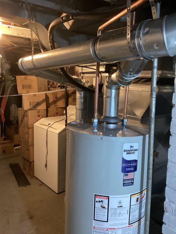 Successfully installed a Bradford White 40-gallon tanked water heater in basement utility area, including proper connection of copper supply lines and drain piping. All mechanical permits were secured in advance and installation was completed according to code requirements with no rebates applicable.