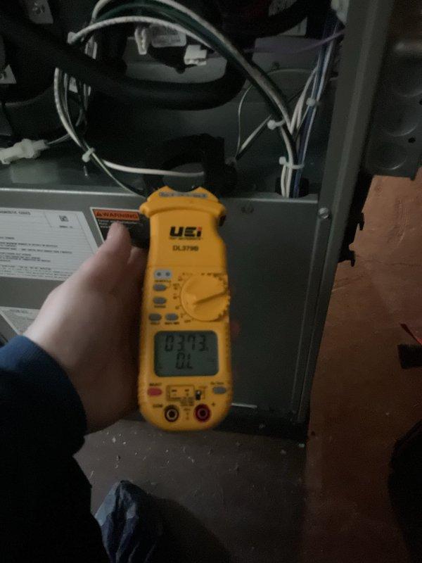 Performed annual furnace maintenance as part of membership agreement. Conducted electrical testing using UEi DL379G multimeter, measuring amp draw on system components. Noted significant debris accumulation on outdoor condenser coil requiring cleaning to prevent efficiency loss and potential system damage.