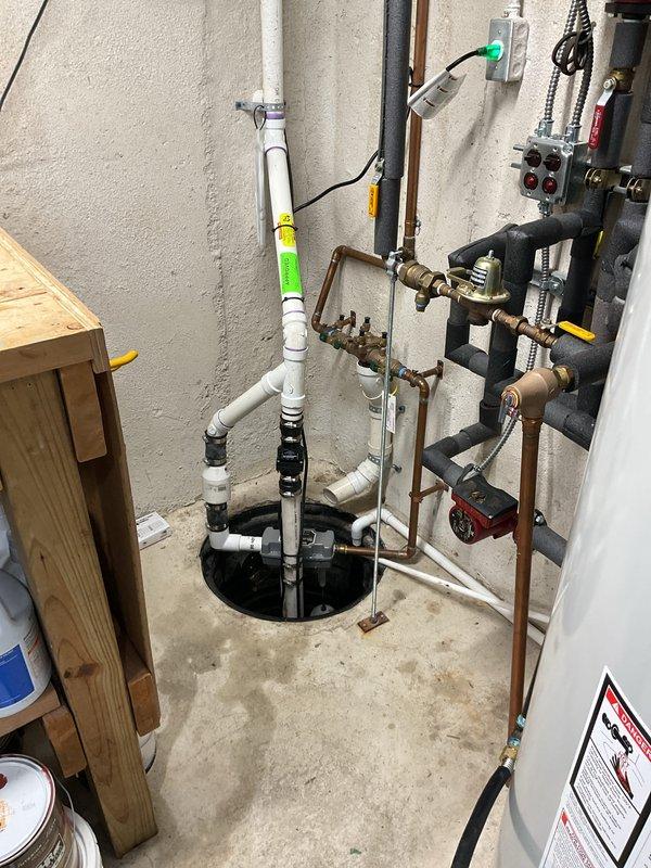Successfully installed a new sump pump system in the basement utility area, including proper PVC piping with appropriate fittings and connections to the sump pit. System features a gray pump unit with control box/sensor components and was fully tested to ensure proper water removal functionality.