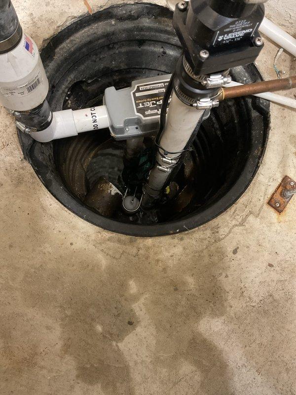 Successfully installed a new sump pump system in the basement utility area, including proper PVC piping with appropriate fittings and connections to the sump pit. System features a gray pump unit with control box/sensor components and was fully tested to ensure proper water removal functionality.