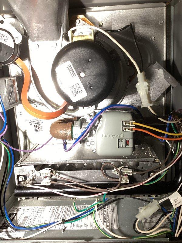 Performed annual furnace maintenance as part of customer's membership program. Inspected and photographed interior components including the blower motor assembly, Honeywell control module, and electrical connections. Examined copper lines and wiring connections throughout the system, noting all components were in proper working condition with no issues identified.