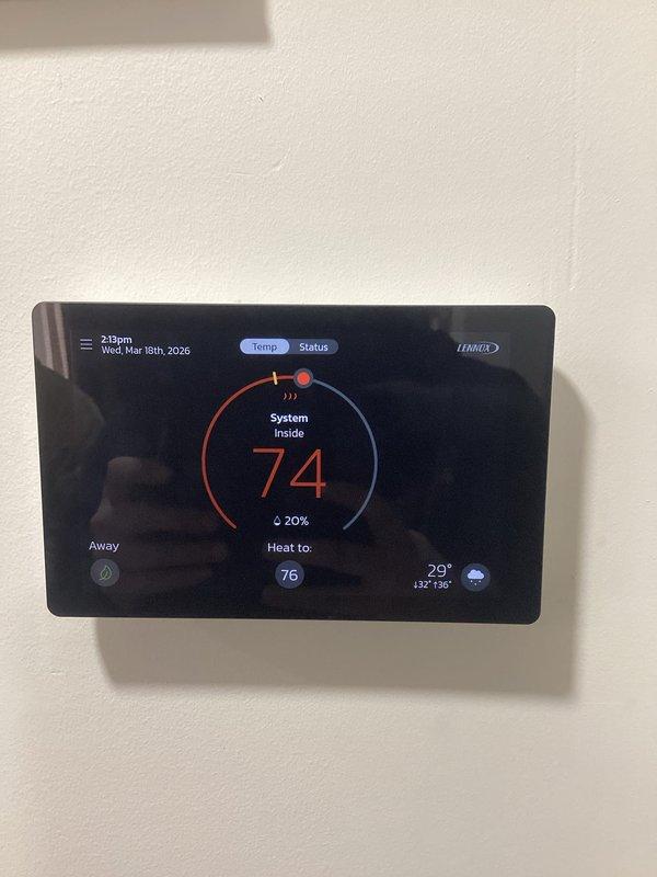 Diagnosed and resolved WiFi connectivity issue on 1-year-old Lennox S40 Smart Thermostat. Confirmed thermostat is now properly connected to home network "Vanessa" with full connectivity to router, ISP and server. System operating normally with heat function maintaining 74°F indoor temperature against 29°F outdoor temperature.