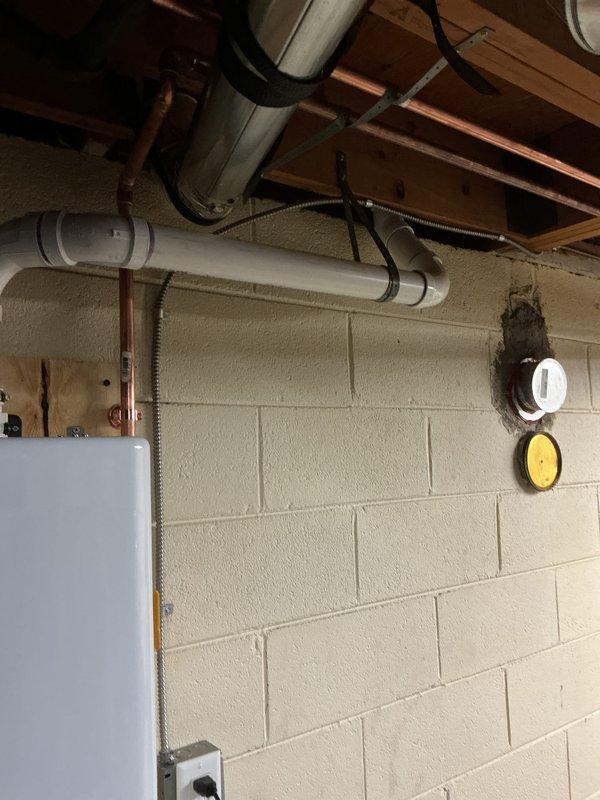 Successfully installed a Navien tankless water heater with Energy Star certification in the basement utility area, mounting the unit on the concrete block wall with proper copper and PVC pipe connections. Completed all required mechanical, gas piping, and reconnection work with appropriate permits, and configured the system to operate at 129°F according to manufacturer specifications.