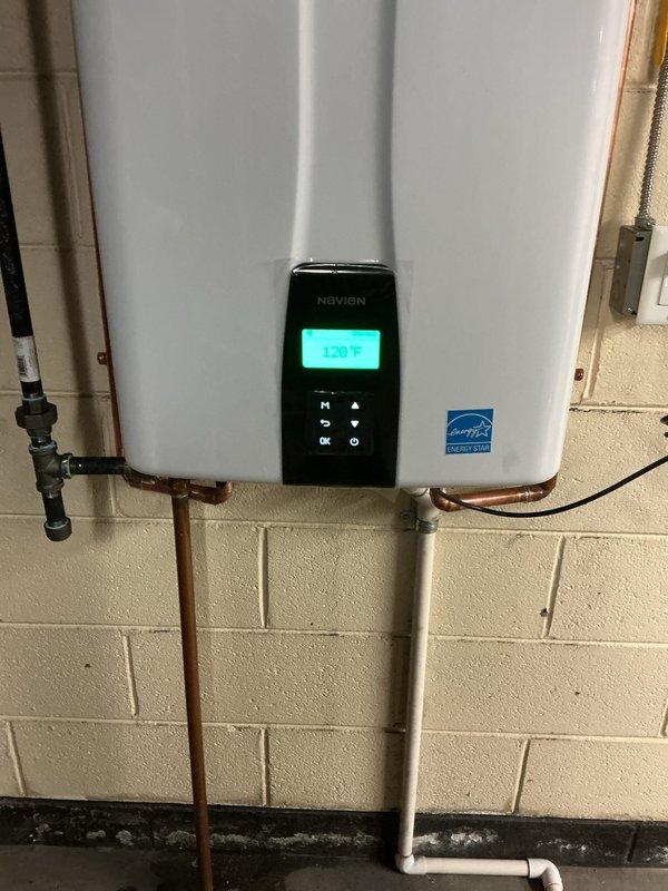 Successfully installed a Navien tankless water heater with Energy Star certification in the basement utility area, mounting the unit on the concrete block wall with proper copper and PVC pipe connections. Completed all required mechanical, gas piping, and reconnection work with appropriate permits, and configured the system to operate at 129°F according to manufacturer specifications.