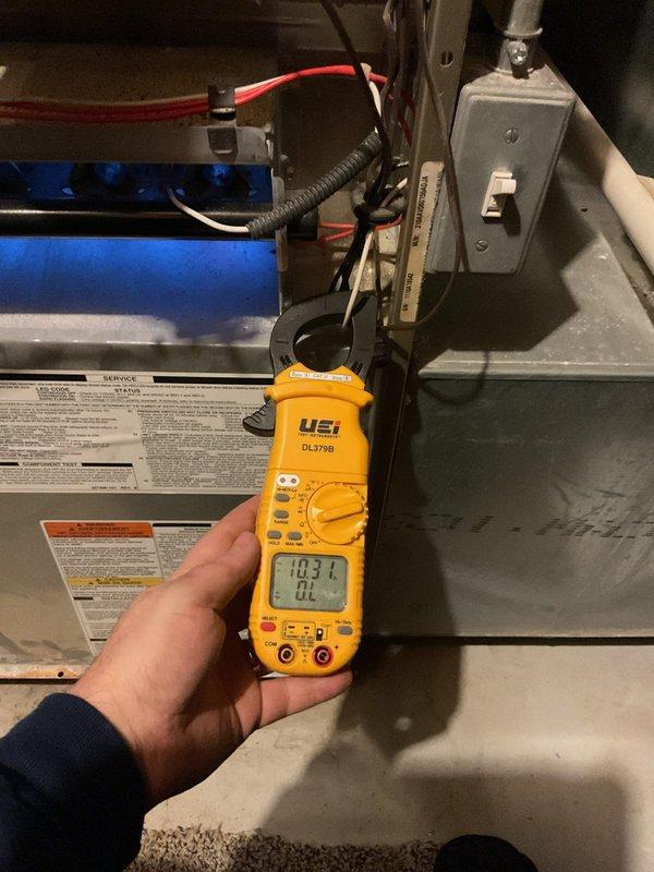 Performed annual furnace maintenance tune-up on unit with CM date of 2025. Conducted electrical diagnostic testing with clamp meter, obtaining reading of 103.1V. Inspected igniter assembly and internal components, noting some dust accumulation within the cabinet. System is functioning properly with all operational parameters within acceptable ranges.