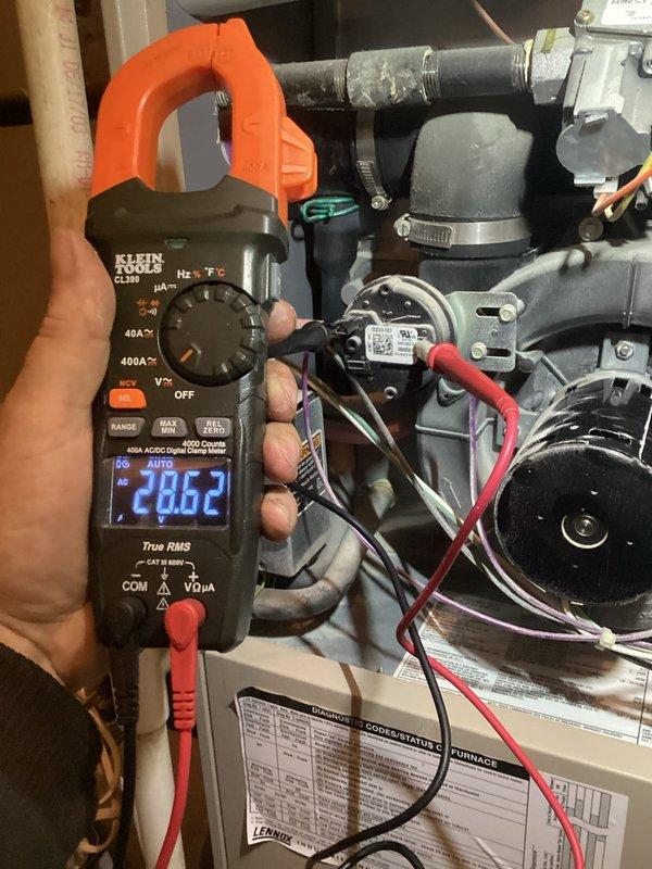 Responded to service call for furnace not heating. Performed diagnostic testing with Klein Tools CL380 clamp meter, measuring electrical current of 28.62 amps through system components. Verified thermostat functionality (White-Rodgers model) was operating correctly with proper temperature readings.