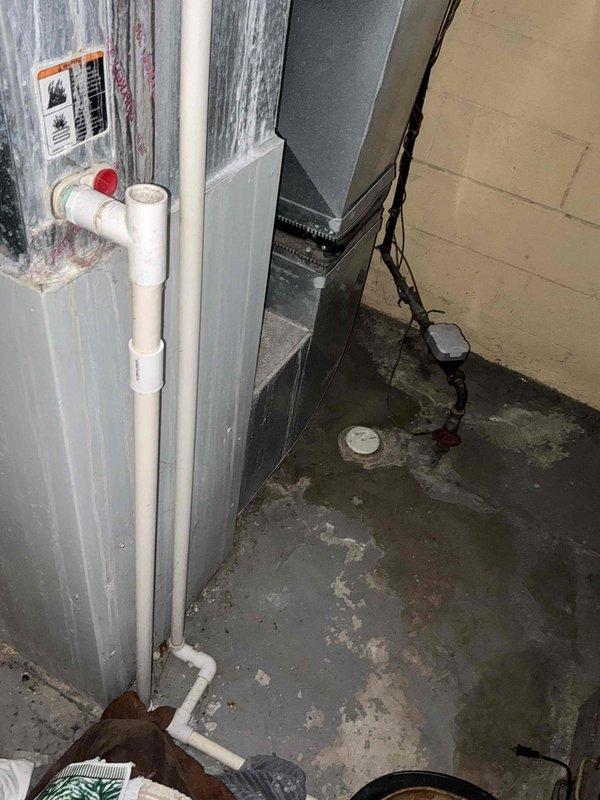 Performed comprehensive inspection of 30-year-old non-functional natural gas furnace located in basement. Assessment revealed significant age-related deterioration, moisture issues evidenced by damp concrete flooring, and outdated ductwork configuration. Recommended complete system replacement due to equipment age, failure condition, and potential efficiency improvements.