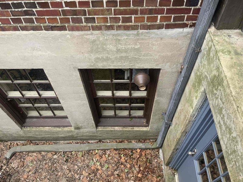 Completed estimate for furnace replacement with photos documenting the existing PVC venting configuration through window frame and the exterior brick/concrete wall condition where installation will occur. Quote includes future air conditioning addition scheduled for June 2025.