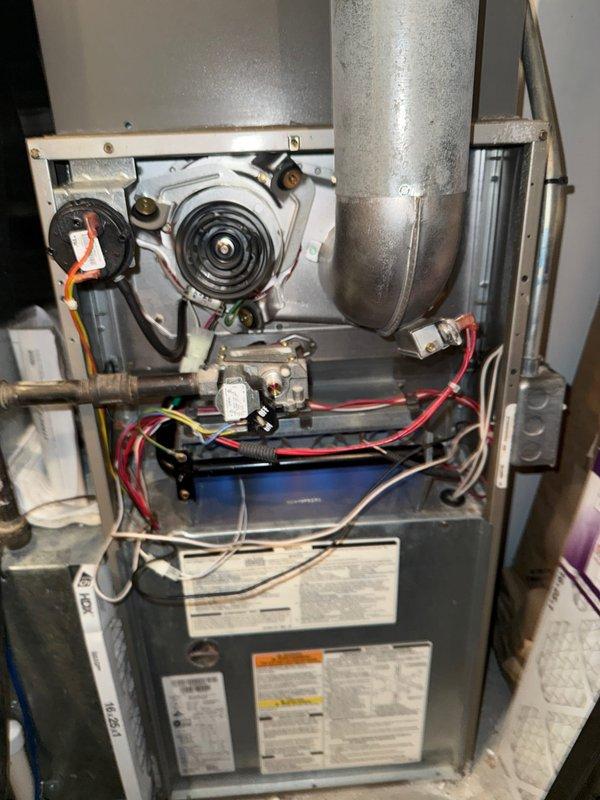 Performed annual heating maintenance on furnace as part of customer's membership service. Inspected blower motor assembly, electrical connections, and control components, confirming all systems are operating correctly with no issues detected. Interior inspection revealed normal dust accumulation but all components are in functional condition with no signs of damage or deterioration.
