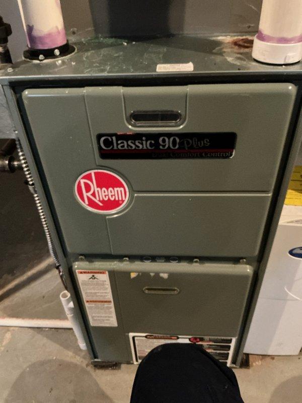Performed complimentary annual heating maintenance on a Rheem Classic 90 Plus furnace with Comfort Control system per membership agreement. Inspected internal components including blower assembly, gas valve, heat exchanger, and electrical connections, finding all in normal working condition with standard dust accumulation. Unit is operating properly with no issues identified; PVC intake and exhaust venting system appears correctly installed and functioning as designed.