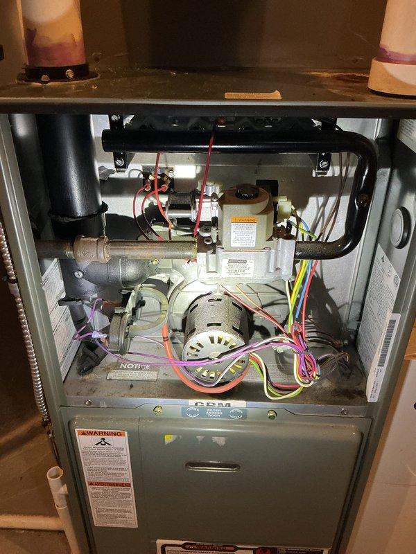 Performed complimentary annual heating maintenance on a Rheem Classic 90 Plus furnace with Comfort Control system per membership agreement. Inspected internal components including blower assembly, gas valve, heat exchanger, and electrical connections, finding all in normal working condition with standard dust accumulation. Unit is operating properly with no issues identified; PVC intake and exhaust venting system appears correctly installed and functioning as designed.