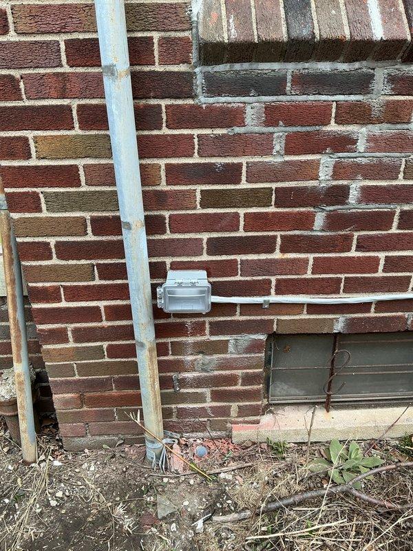 Completed required electrical violation repair by installing a 125V outlet to service the new 3.5-ton A/C unit. Properly connected the outdoor condenser unit in the rear yard and installed matching indoor coil as specified in the original work order. Took verification photos of the completed electrical junction box installation and equipment placement.