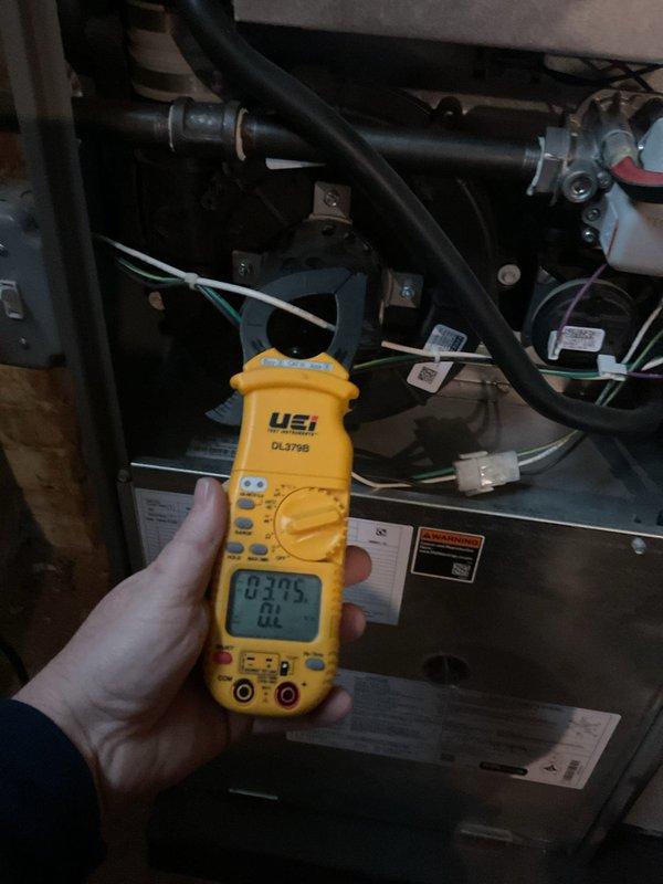 Completed 5-Year ComfortGuard Maintenance Visit on HVAC system. Performed electrical diagnostics using UEi DL379B clamp meter, measuring current draw with readings of 03.75 and 02.12 amps at different test points. System operating within normal electrical parameters with no specialty service required.