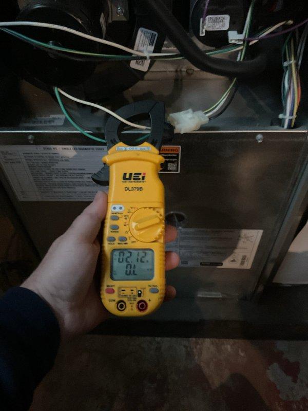 Completed 5-Year ComfortGuard Maintenance Visit on HVAC system. Performed electrical diagnostics using UEi DL379B clamp meter, measuring current draw with readings of 03.75 and 02.12 amps at different test points. System operating within normal electrical parameters with no specialty service required.